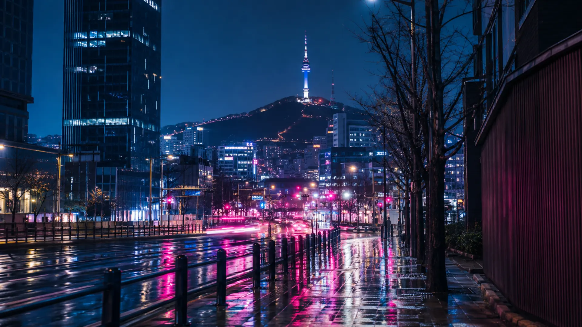 Seoul skyline at night with N Seoul Tower above neon-lit streets